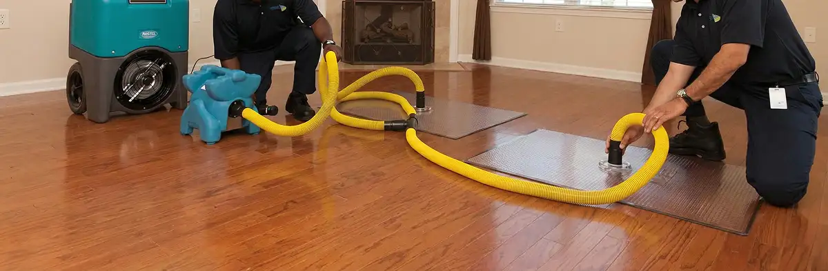emergency water removal technicians extracting standing water from a home using professional equipment in Green Bay, WI