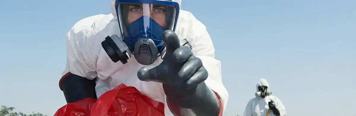 sewage clean up technician wearing protective gear handling biohazard materials in Green Bay, WI