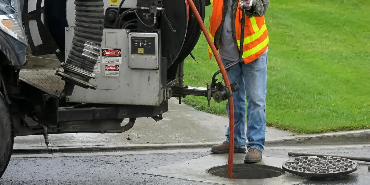 sewage clean up professionals using industrial equipment to remove contaminated wastewater in Green Bay, WI