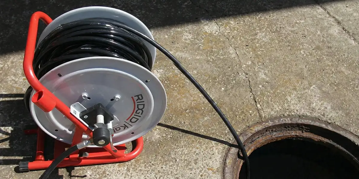 sewer rodding equipment prepared to clear clogged sewer lines in Green Bay, WI